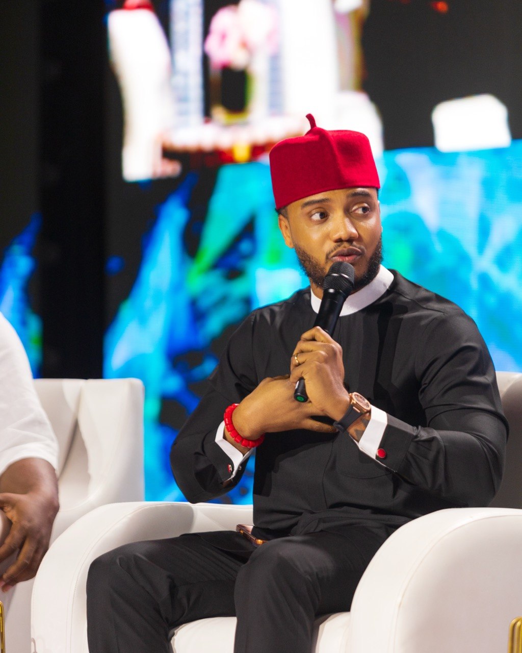 Harrison speaking on stage at FDX Nigeria